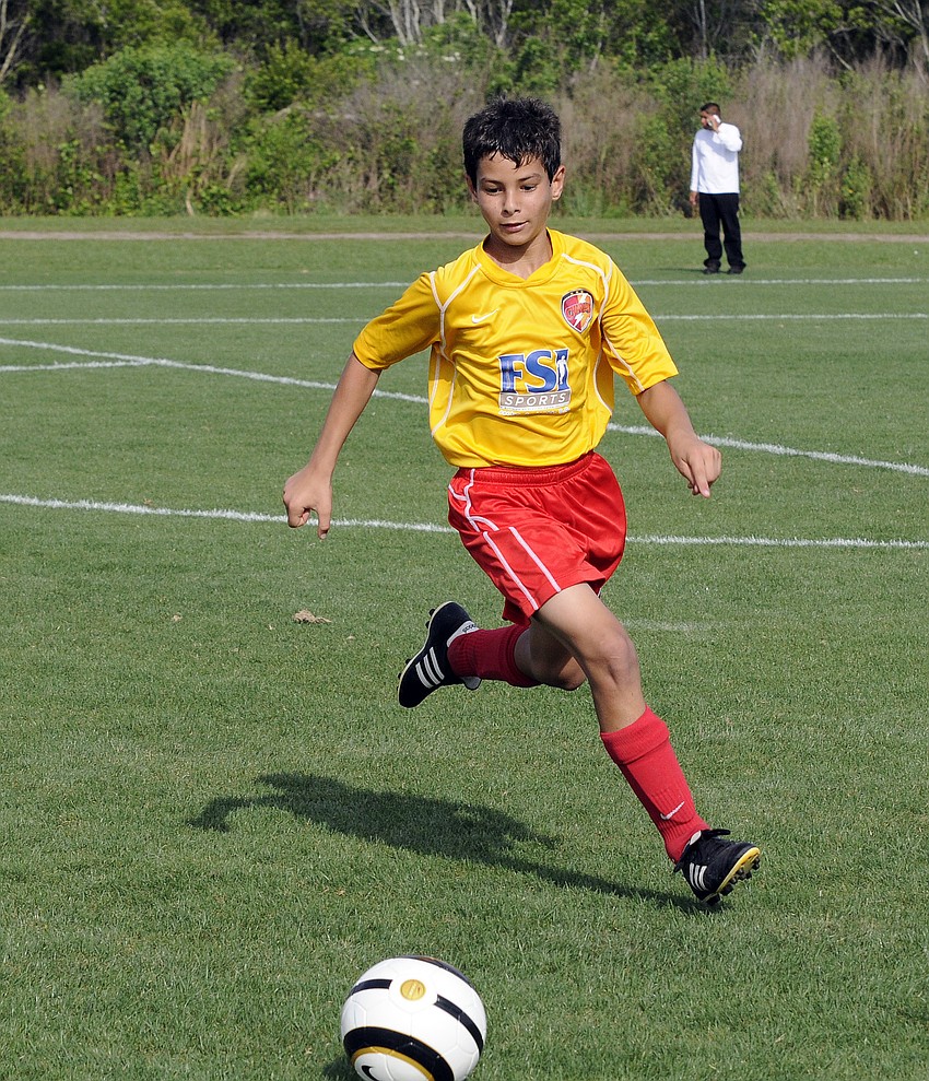 Twelve-year-old Joseph Gigliotti races to the ball during the Lakewood Ranch Chargers U12 teamâ€™s game against Strictly Soccer.