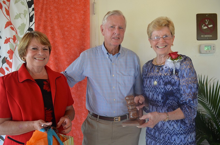 Bob Haynes made Sue Angle a gavel out of wood. Olivia and Bob Haynes present the gift to Sue Angle.