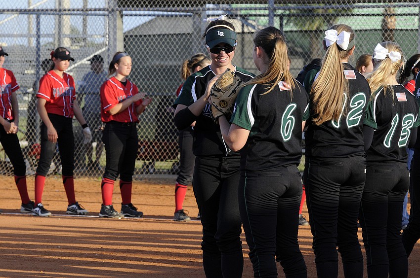 Lakewood Ranch senior Taylor Newton high fives her teammates before the start of the Class 6A-District 12 championship April 19.