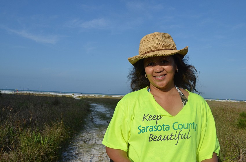Beverly Arias helped pick up trash at Siesta Key Beach.