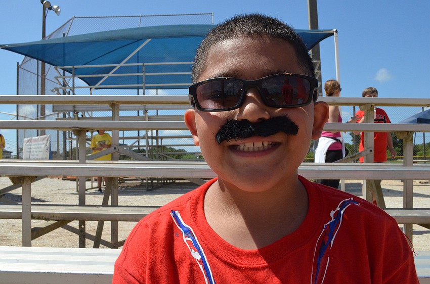 Eric Negroni watches the baseball game from the bleachers.