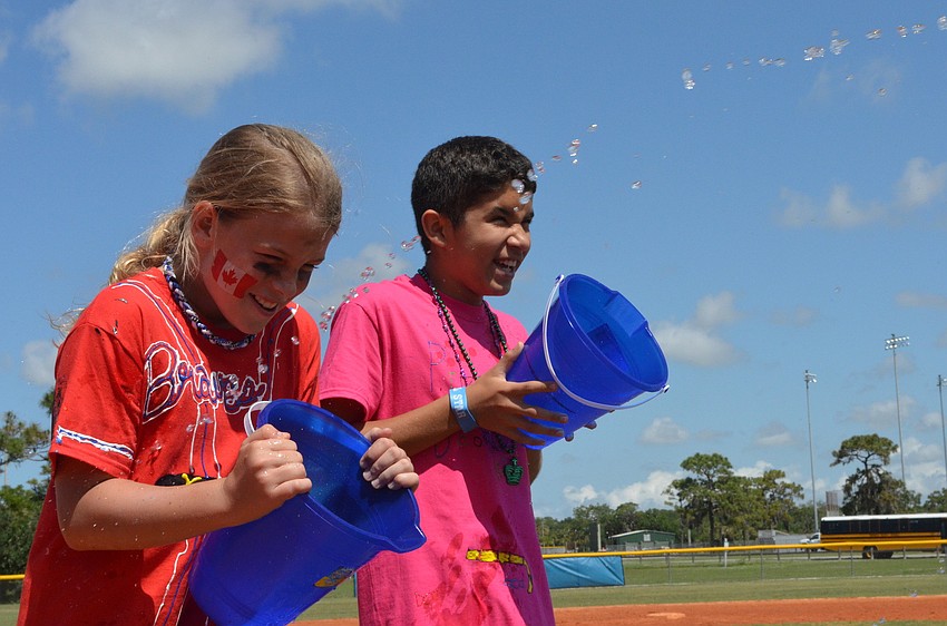 Riley Stroth and Christian Soloranzo are on the receiving end of the water game where their partners shoot water across into their buckets.