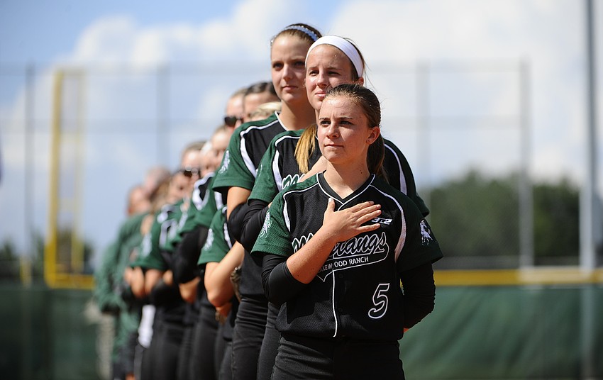 Lakewood Ranch freshman Maddie Biggs and the rest of the Lady Mustangs softball team listen to the National Anthem before the start of their regional final game.