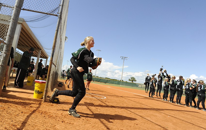 Lakewood Ranch starting pitcher Amanda Rak runs out onto the field before the start of the game.