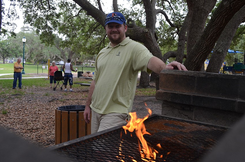 Vice Chair of the Arlington Neighborhood Association David Morgan starts to light the coals.