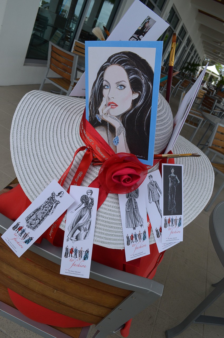 Mary Mitchell is a fashion illustrator and designed this hat. She put postcards of her illustrations and paintbrushes in her hat.