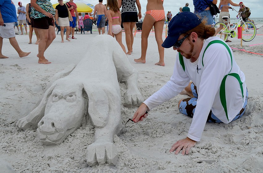 Dean Arscott carves a sculpture for Ocean Potion.
