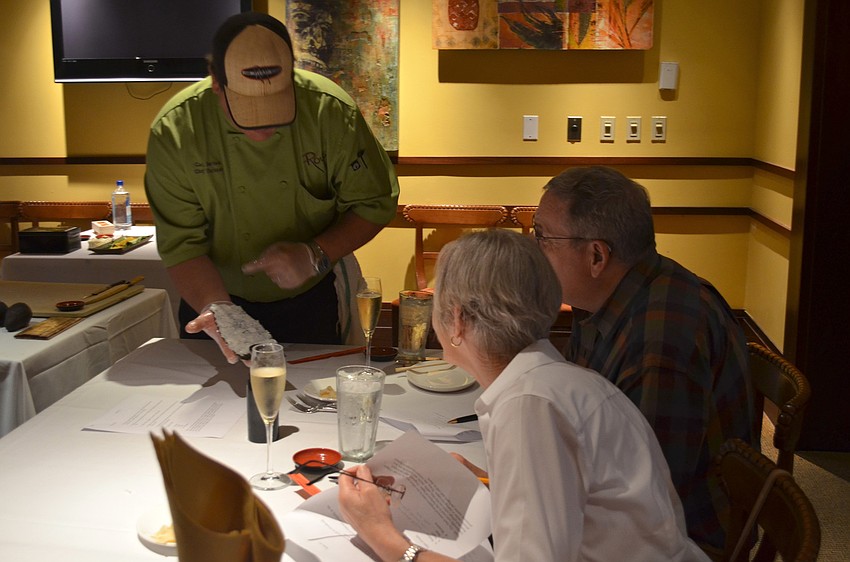 Chef Carl Bertka shows Ginny and Werner Schuele how rice is properly placed on the nori.