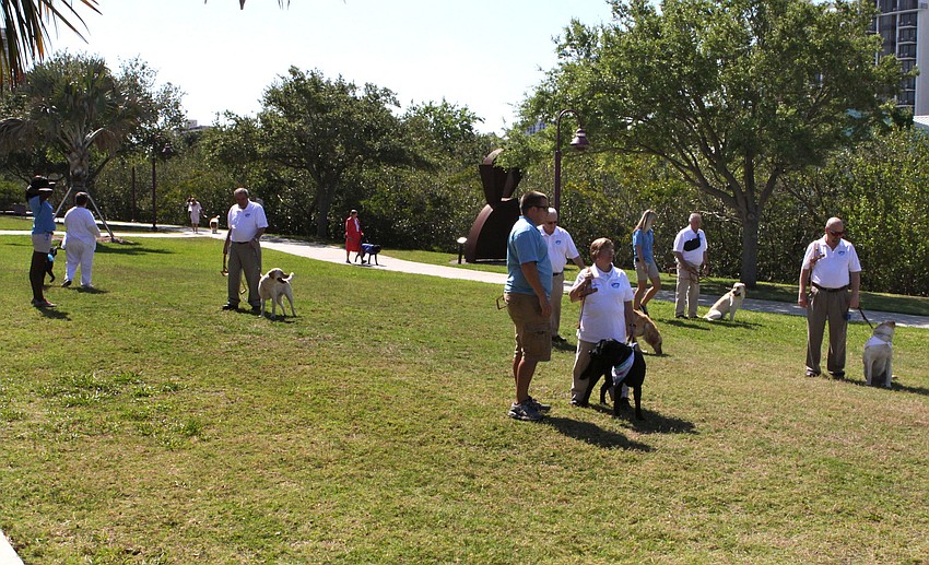 The graduates walk their dogs around on the grass at Van Wezel prior to their graduation ceremony.