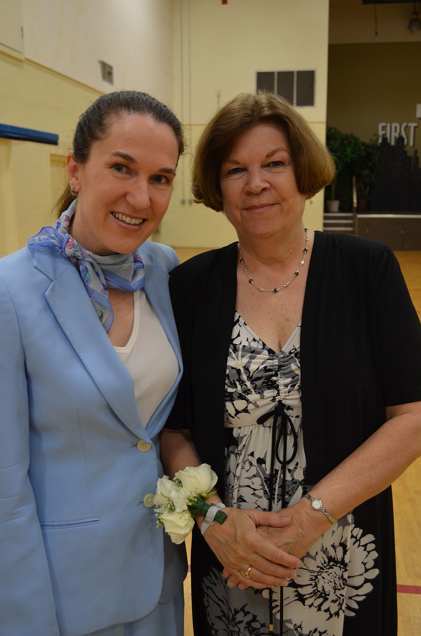 Courtney Goodman gives her mom Jean Bittinger a white rose corsage for Mothers Day.