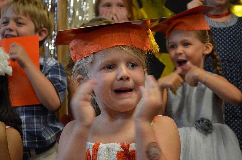 Addie Litherland sings a song with her classmates at the close of the graduation.