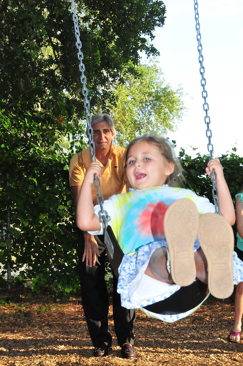 Ari Benson soars to the sky with a little help from her Bumpa (grandfather) after her graduation from Pre-K.