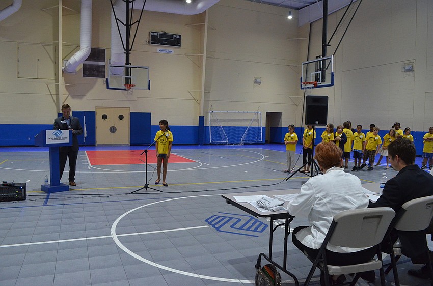 Larry Bowman reads a word to Wilkerson Elementary fourth grader Aaliyah Burstein.