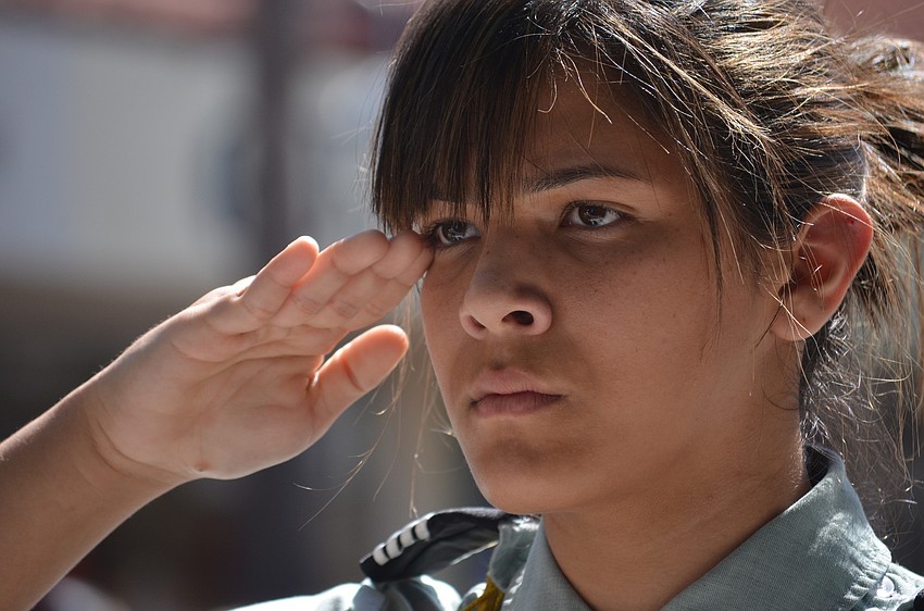 Booker High School JROTC Cadet salutes veterans.