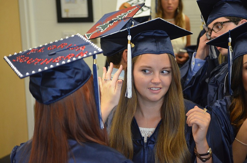 Amelia Summersbee adjusts classmate Alyssa Masonâ€™s cap.