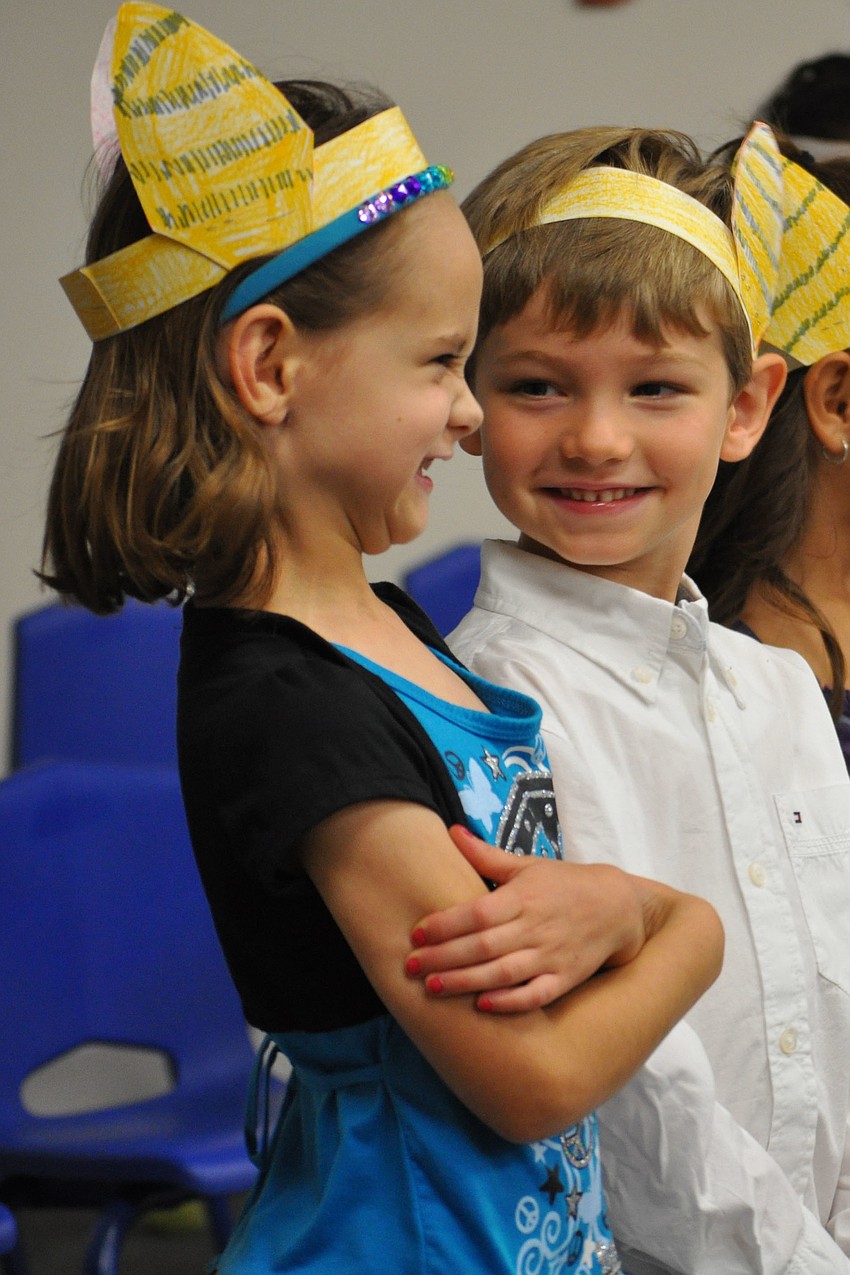 Natalia Chadbourne and Michael Merino giggle with excitement, during part of Kiddie Academy's ceremony.