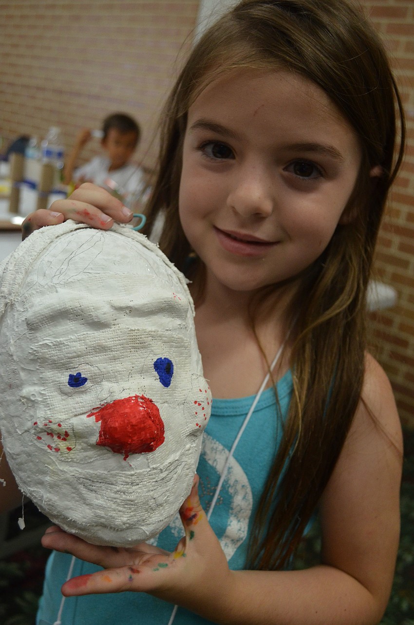 Luci Perales, 6, shows of her renaissance inspired mask.