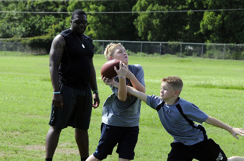 Nine-year-old Mack Woolever, right, breaks up a pass intended for 9-year-old Luke Toole.