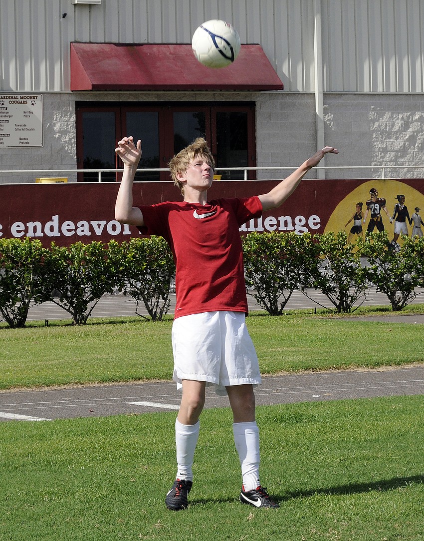 Cardinal Mooney freshman defender Justin Ahlquist goes up for a header.