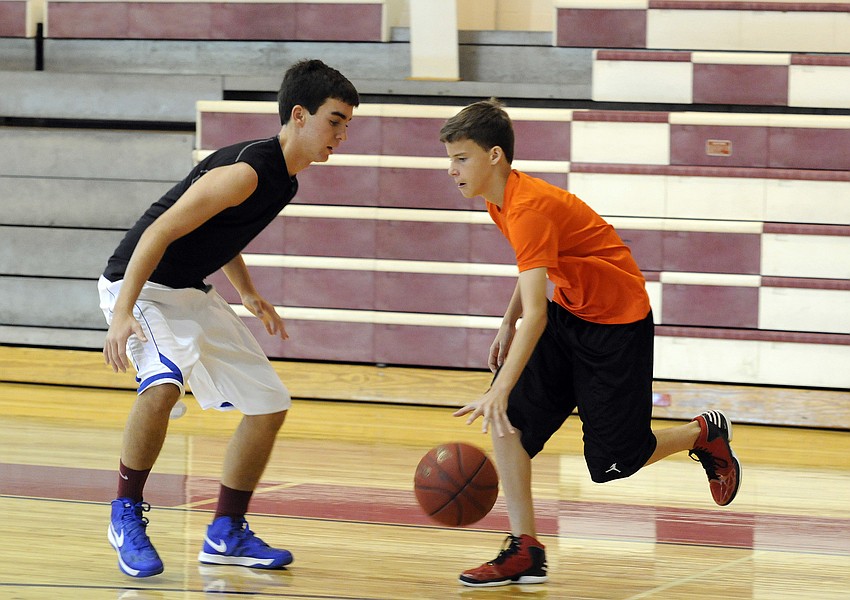 ODA eighth-grader Matthew Luhrsen attempts to dribble past Cardinal Mooney freshman Mac Sacco.
