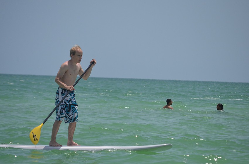 Jacob Steingart was visiting from the Boston area and tried out paddle boarding while hanging out on the beach.