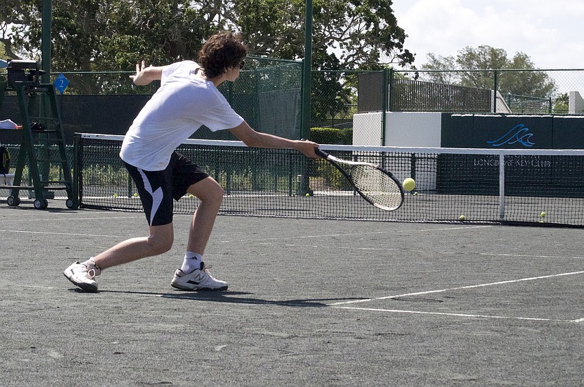 Thibult Bachelet, 16, reaches to send a ball to the opposite side.