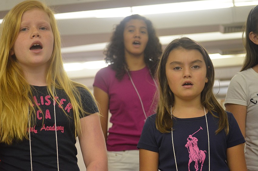 Eloise DeVary, Emily Roberts and Jamilah Hurd sing during chorus class.
