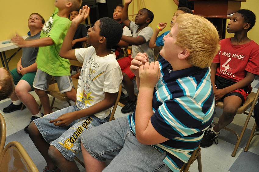 Josh McKiddin, front, celebrates as the boys' team earns a point, during a game of 