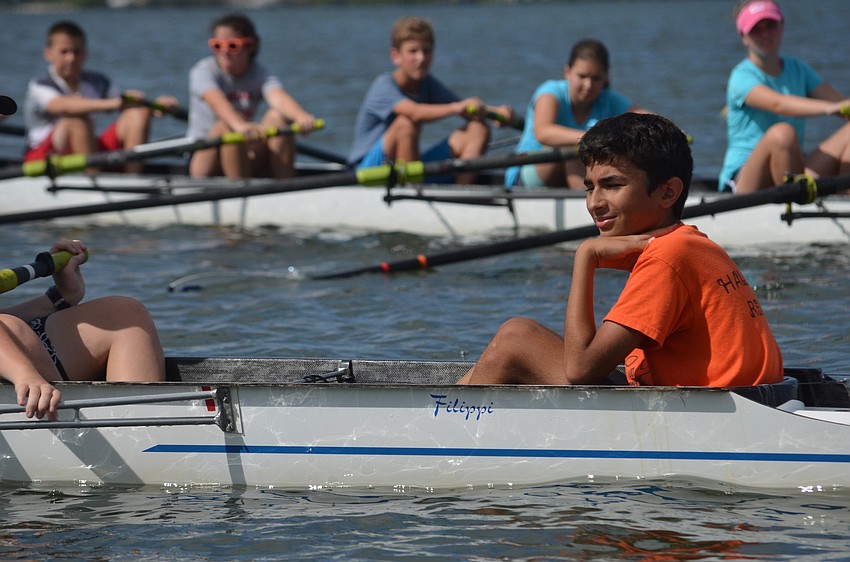 Ali Abdel-Qadar helps beginners with steering the boat.