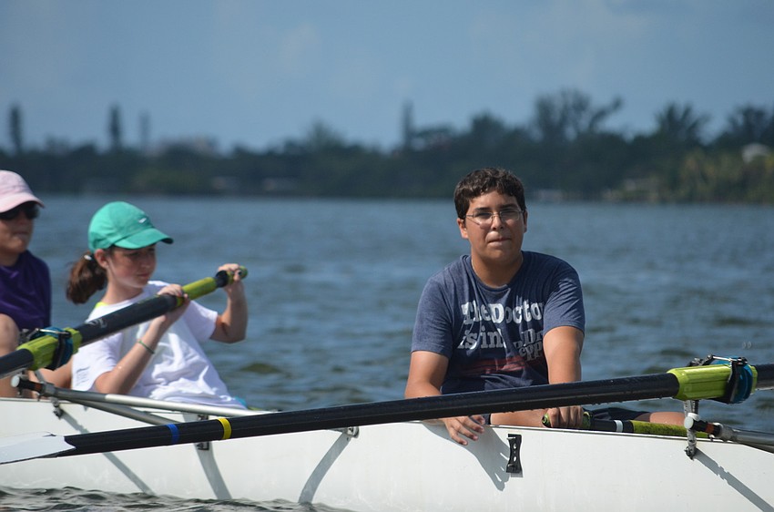 Matthew Fasold rows with other campers.