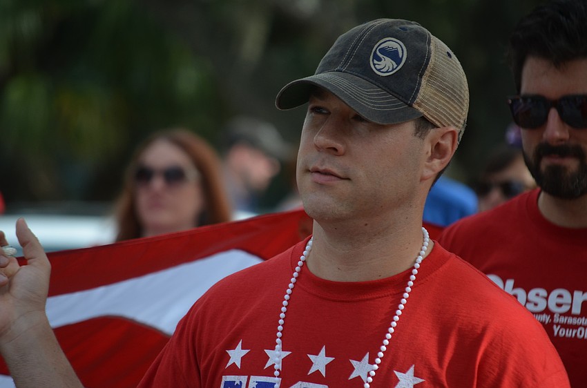 Adam Hughes marches with Observer staff members in the parade.