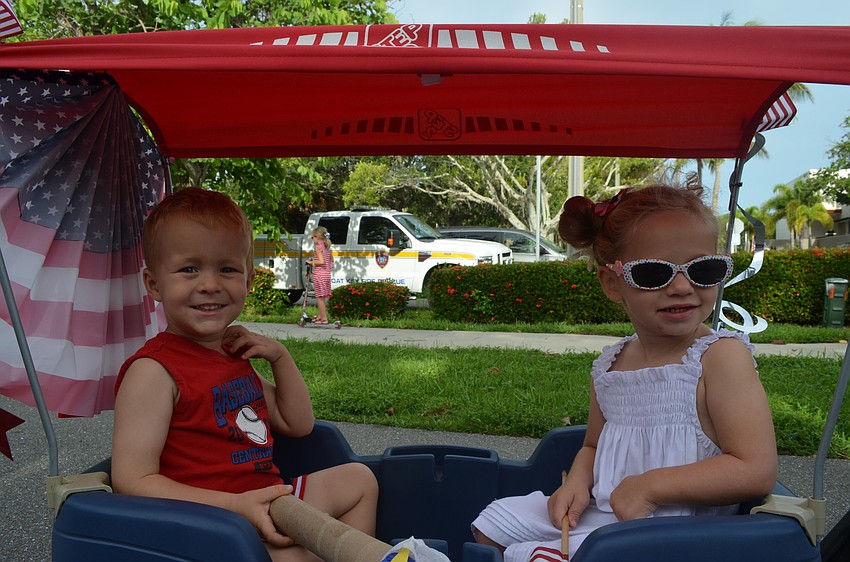 Colin Bankert, 2, and Gigi Tuffile, 3, ride in the parade in style.