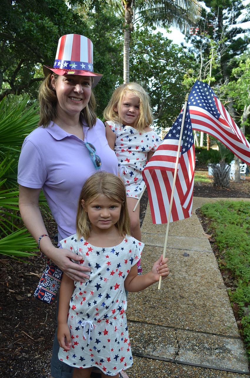 Jami Sharik and her daughters Sandy, 5, and Susan, 3, wave their flags at Freedom Fest.