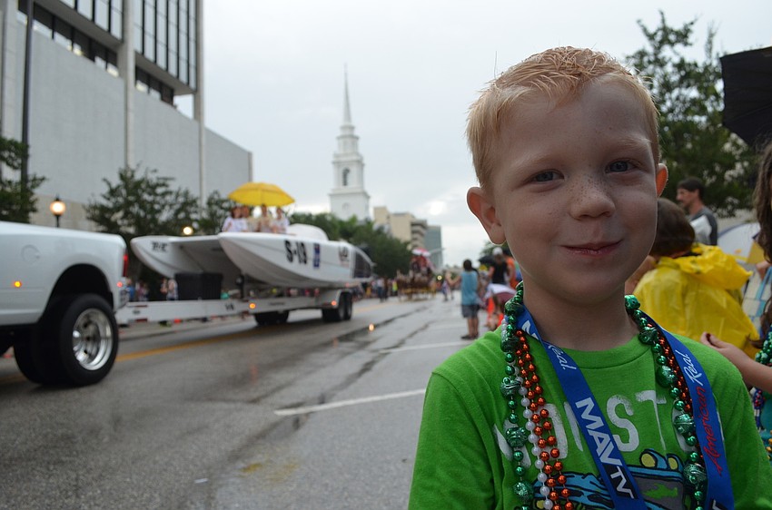 Hayden Hackler, 4, has a great time collecting beads, dancing and watching the parade.