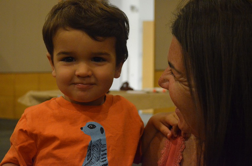 Lucas Seng, 2, plays with his mother Sara.