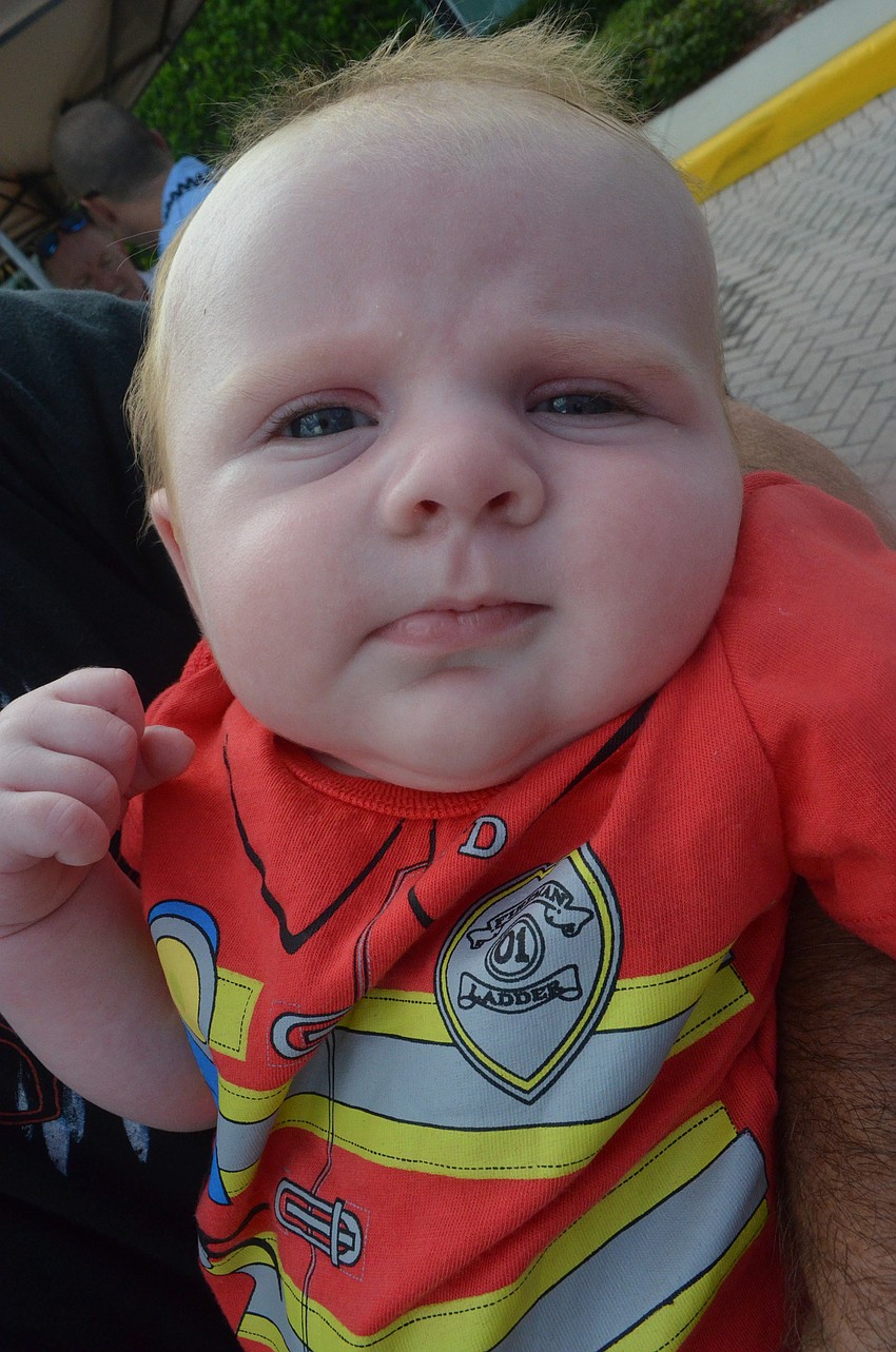 Two-month old Lexi Schaffer wears a firefighter onesy since both of her parents are firefighters.