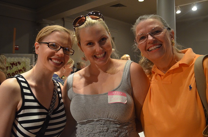 Maid-of-honor Sam Paul helps bride-to-be Bond Cort looking for a gown with Cortâ€™s mother Susan.