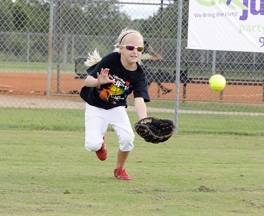 Sarasota Heat 10U third baseman Rylee Miller, 9, dives for a fly ball.