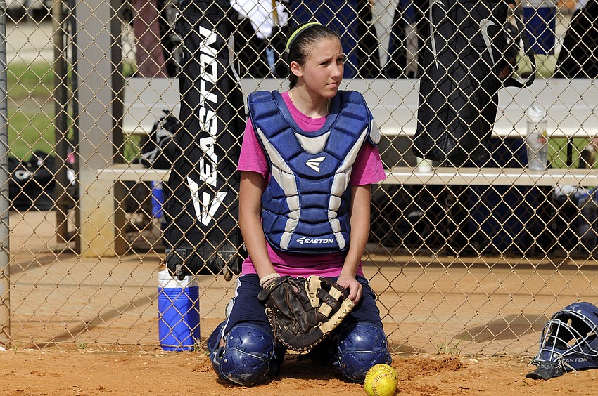 Twelve-year-old Breanne Mazzella receives instruction before taking part in a series of catching drills.