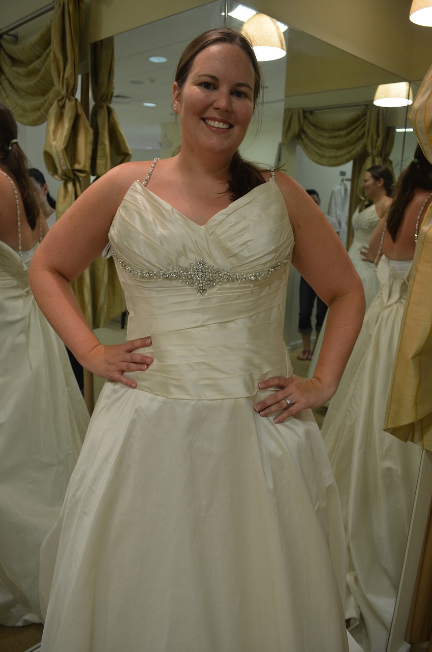 Melissa Smith tries on a wedding gown at the Brides Across America event.