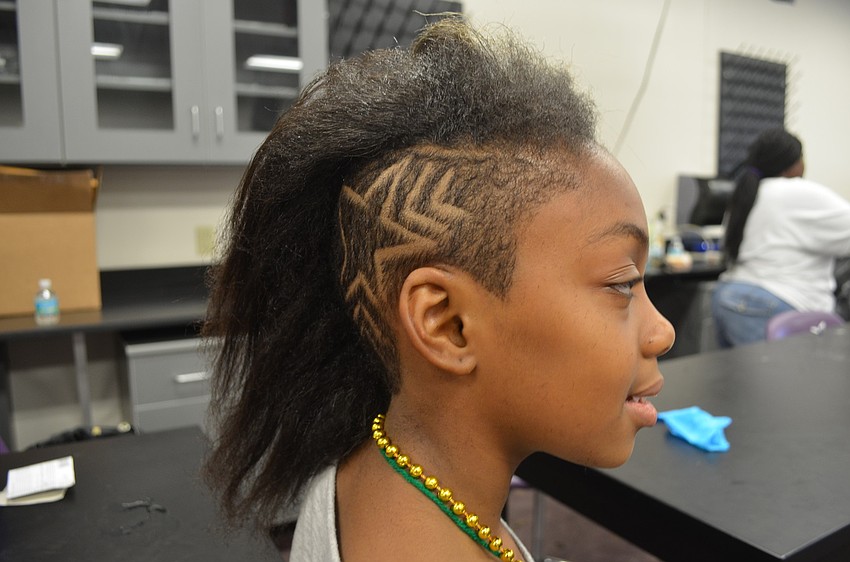 Amaya Saunders, 10, gets a star put in her hair. She will be back at Phillippi Shores Elementary in August.