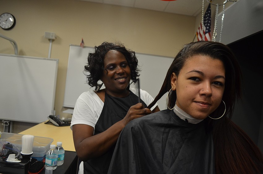 Shalonda Robinson of Smart Style volunteers her time and does 17-year old Alexis Bowersâ€™s hair.