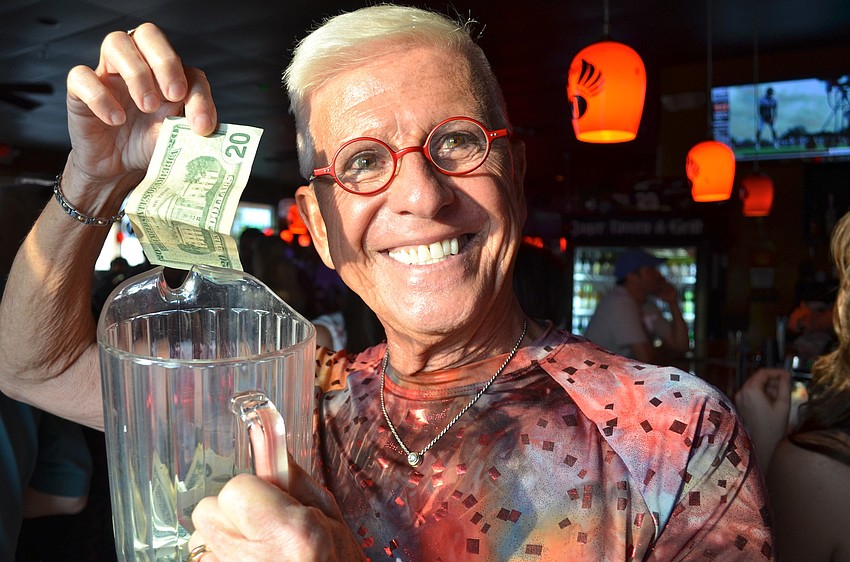Emcee Bob Trisolini shows us the money raised â€”Â by 7 p.m., he emptied 5 buckets-full.