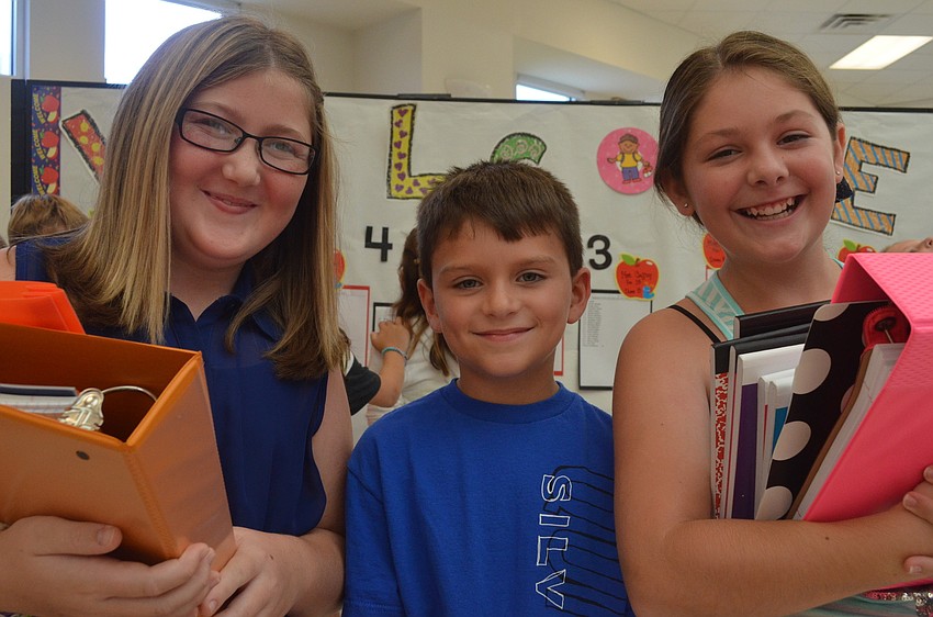 Emily McGregor, 11, gears up for school with her cousins Gage, 7, and Ruby, 11. Ruby and Emily are both entering sixth grade and Gage is entering second grade.