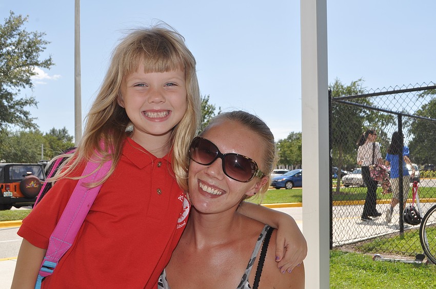 Christina Harrington picks up daughter Dominique, 6, from her first day at Phillippi Shores Elementary.