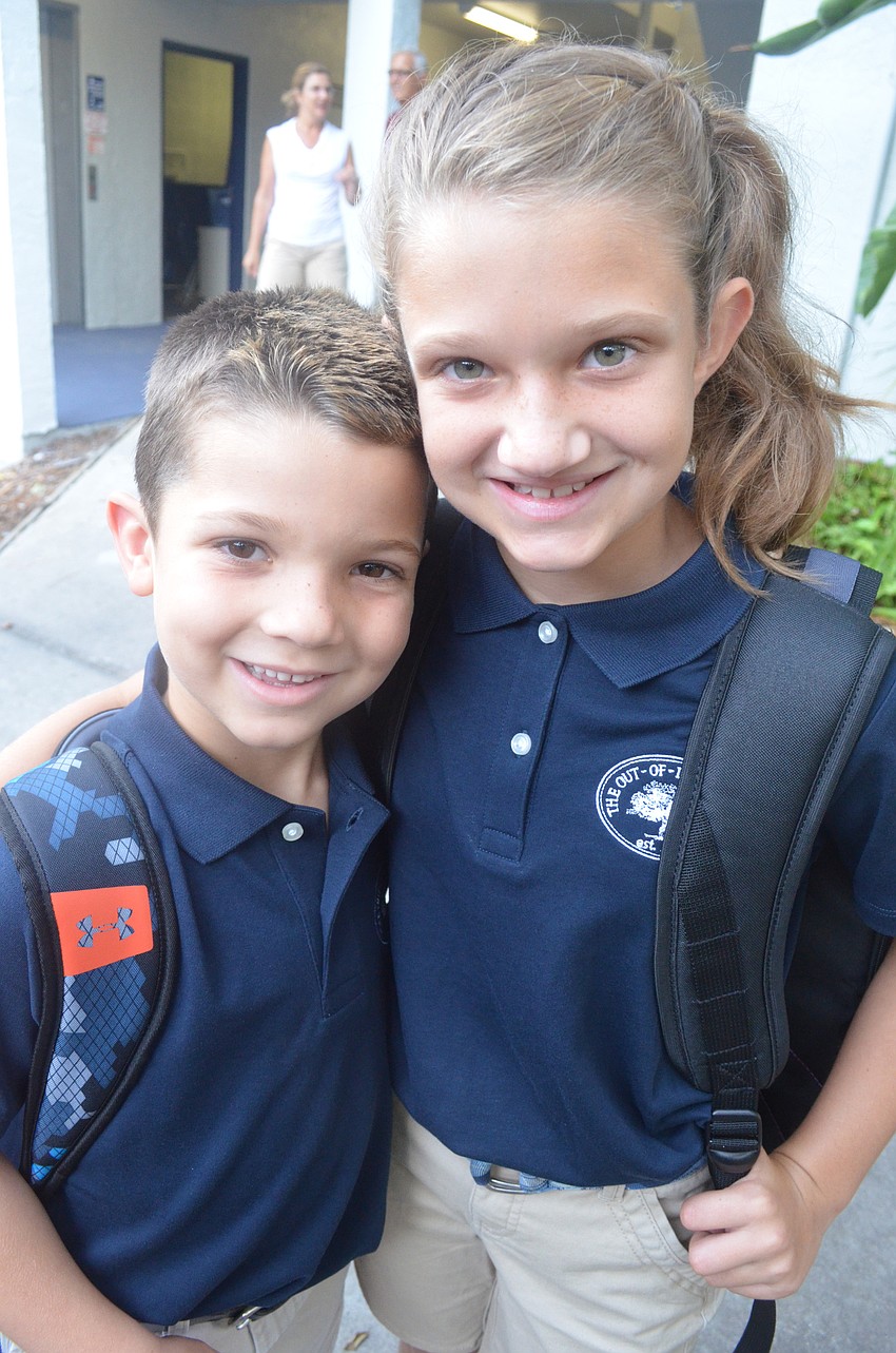 Heather S., 10, says goodbye to her little brother Johnathan, 7, as she heads to fifth grade and he heads to second grade.