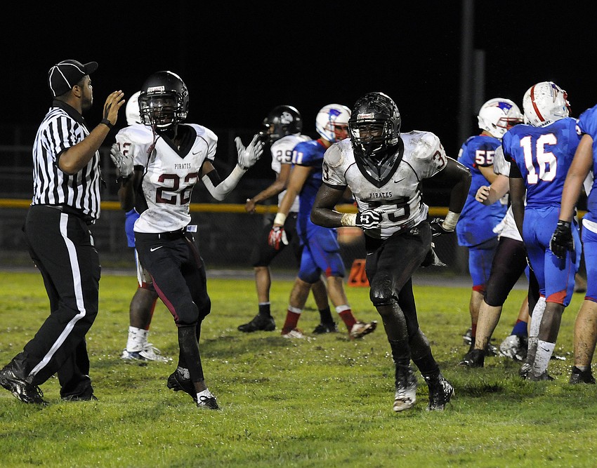 Kedarius Smith and Joseph Evans celebrate following one of the Pirates three fumble recoveries.