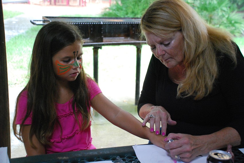 Activities included nail painting. Jackie Apatow paints Alexandra Witherspoon's nails.