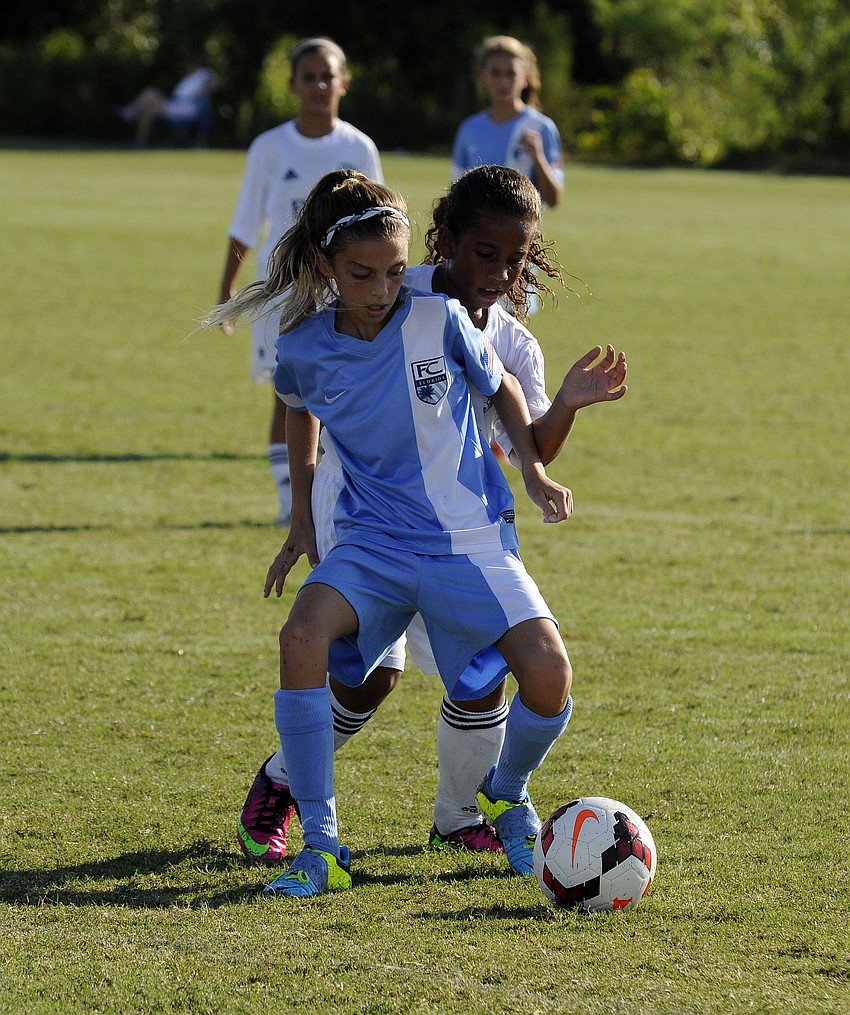 Ten-year-olds Caroline Oâ€™Keefe and Kayla Banks battle for possession.