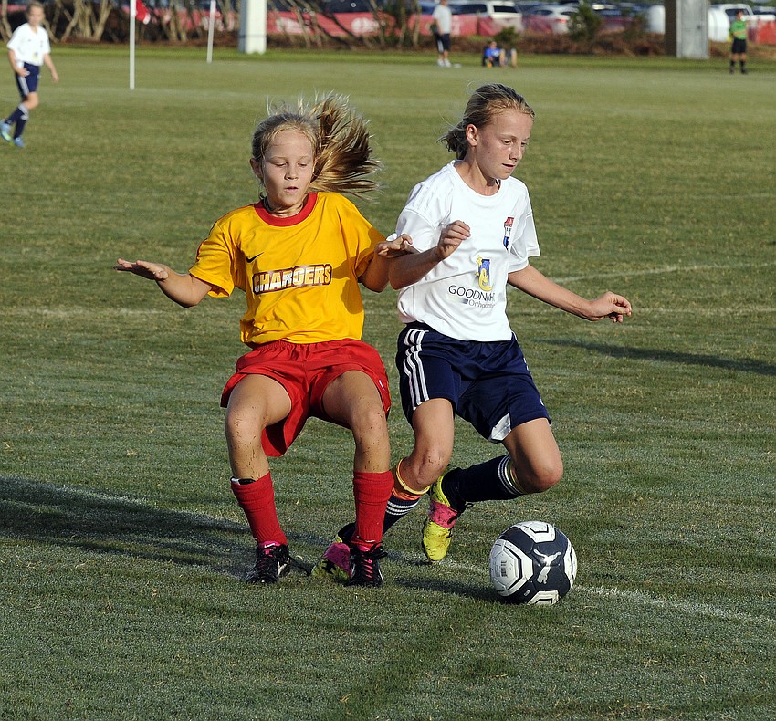 Tampa Bay United Southâ€™s Quinn Ryan, right, attempts to keep a Clearwater Chargers defender from taking possession.